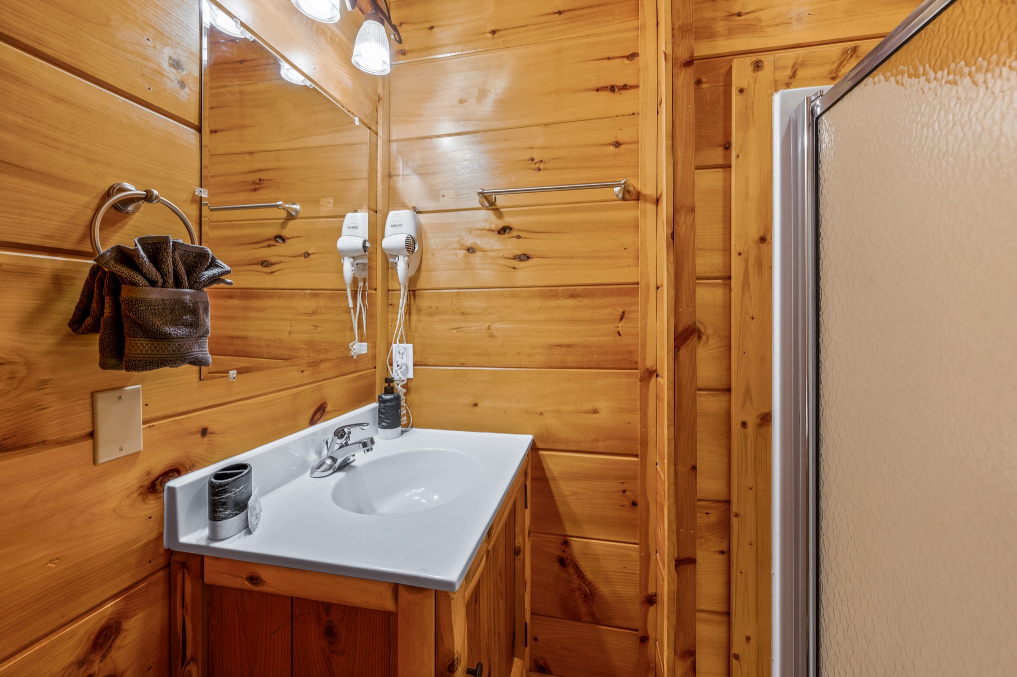 Basement bathroom vanity at Bearadise with wood paneled cabinetry